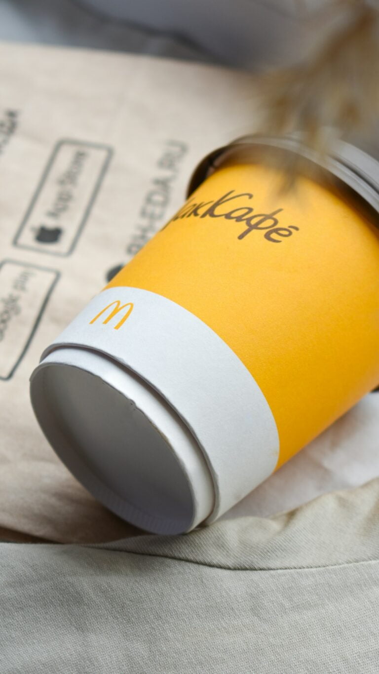 a coffee cup sitting on top of a piece of paper